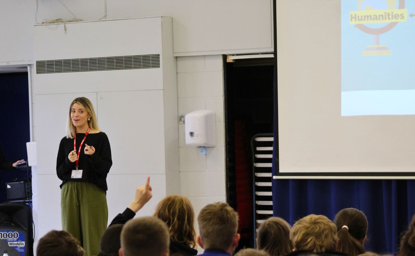 A person speaking in front of a group of students